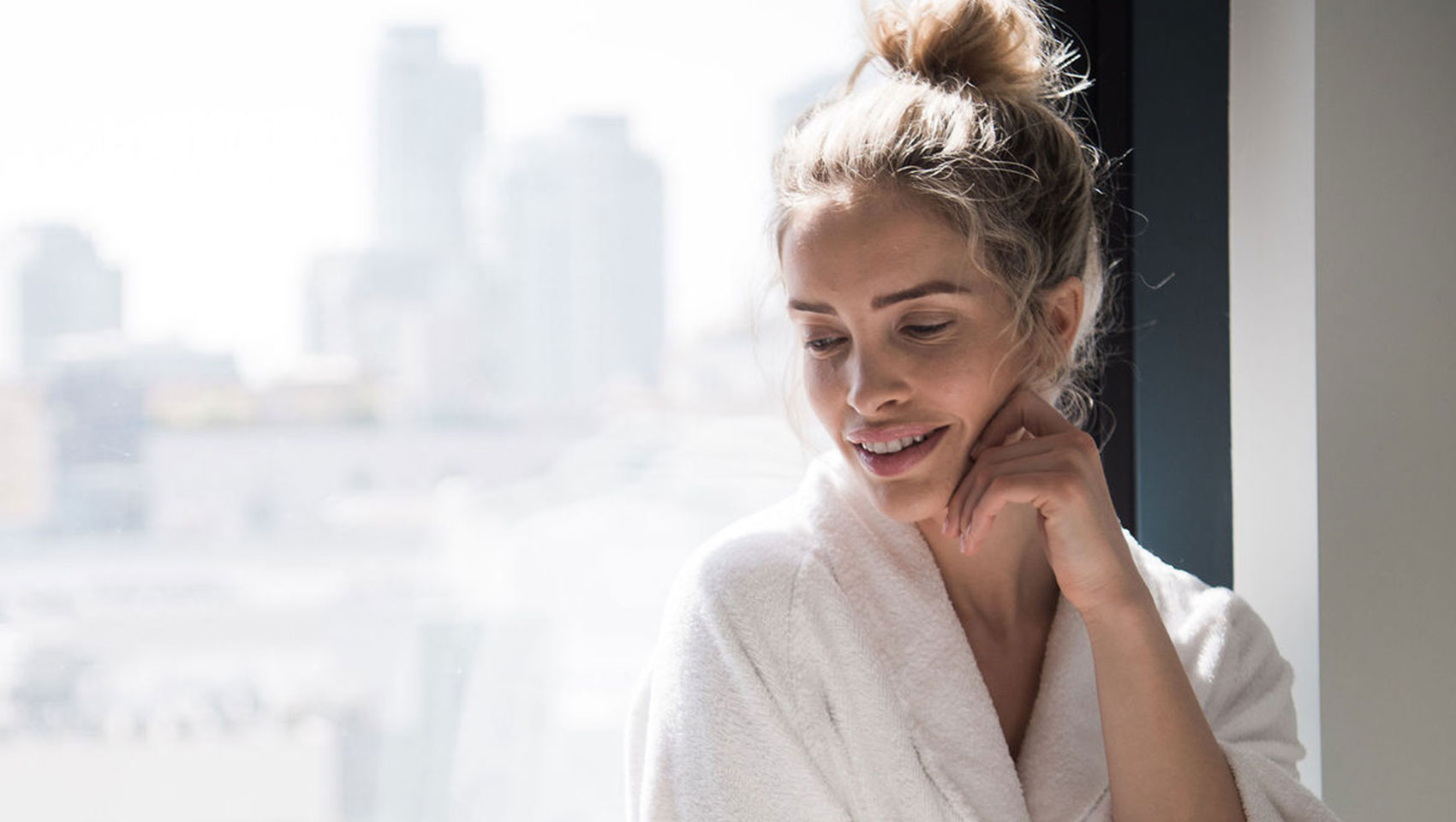 Woman sitting at window in robe