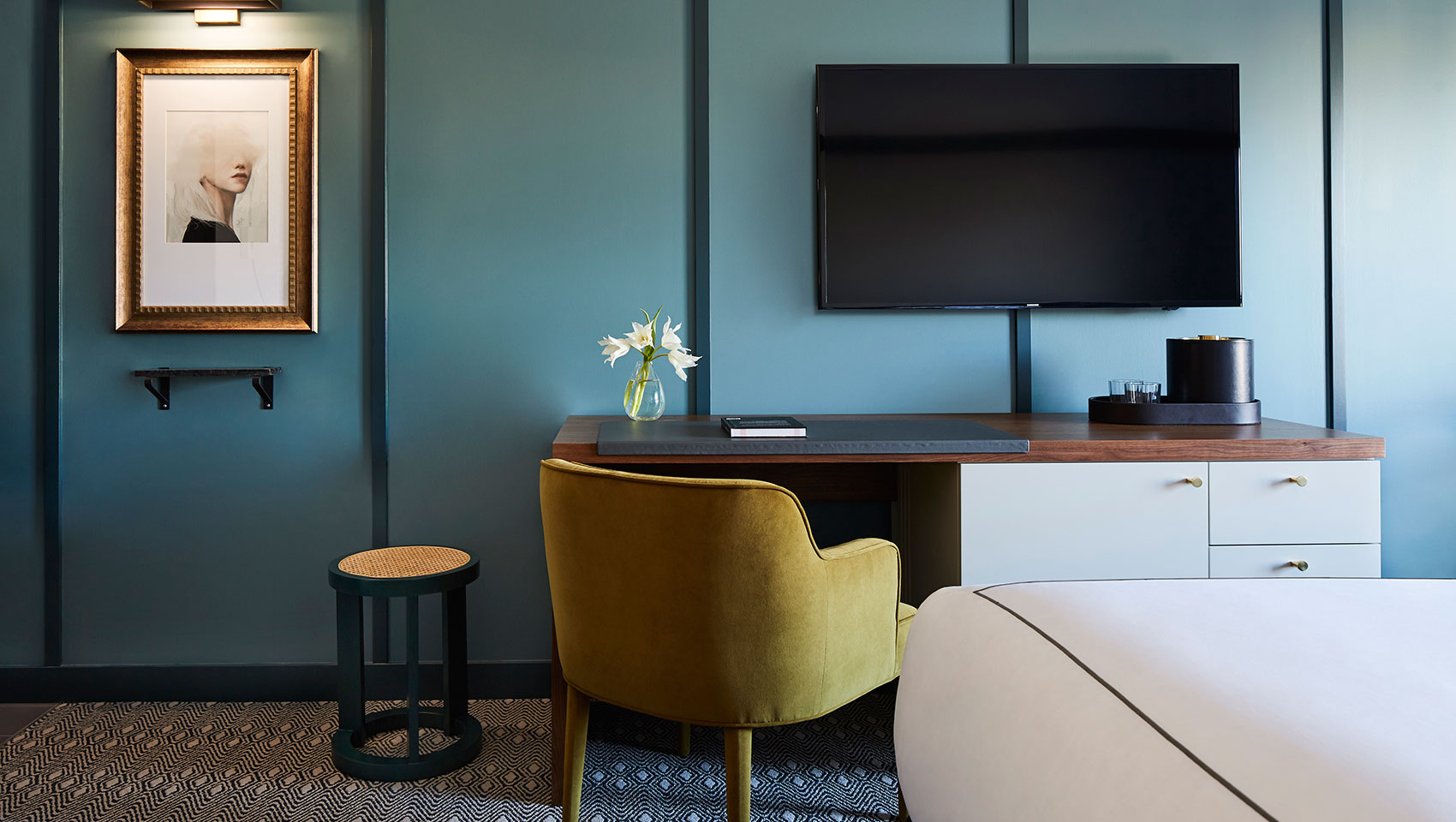 Green wall, TV, Mustard chair, workspace