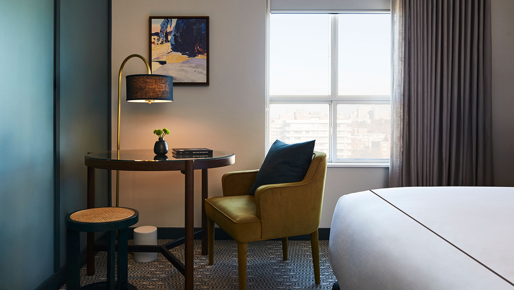 Wooden table and yellow chair lit with overhead lamp, corner of the room